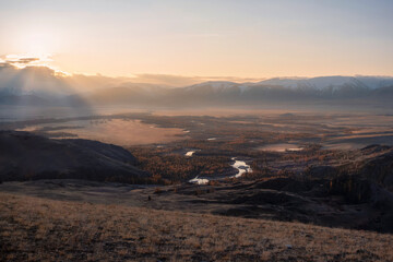 magical dawn with a misty haze over a winding river