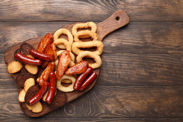 Set of assorted beer snacks - grilled sausages, roasted chicken wings, croutons, deep fried onion...