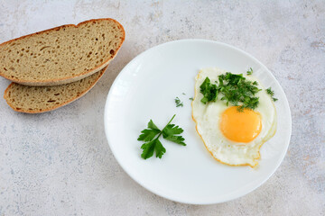 a plate with an egg and parsley on it  