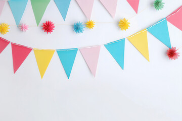 Obraz premium Colorful paper bunting banner with colorful triangular flags on white background. AI Generated