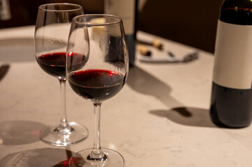 Tasting of red dry Saint-Emilion wine aged in French oak wooden barrels in cellar, Saint-Emilion wine making region, France, Bordeaux