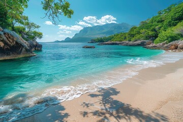 Pristine sandy beach with crystal-clear turquoise water, surrounded by lush greenery and mountainous terrain