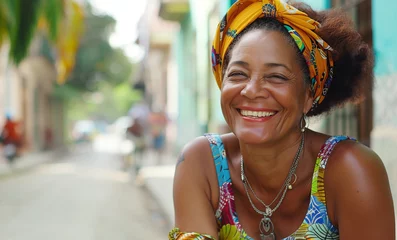Tuinposter Close up portrait of beautiful aged old Cuban woman with kind eyes cheerful smiling at camera. Female dressed bright dress and sitting on colorful narrow Caribbean little town street. © Train arrival