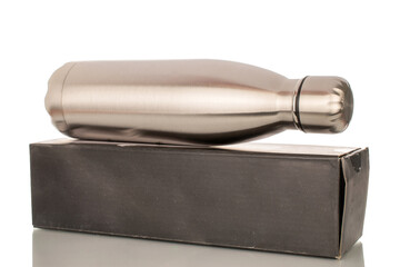 One metal thermos bottle with paper box, macro, isolated on white background.