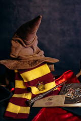 Fototapeta premium Kremenchug, Ukraine - March 21, 2024. Book of Spells, Ticket for the Hogwarts Express from platform 9 3.4 and JK Rowling's Harry Potter Magic Wand. Composition of accessories