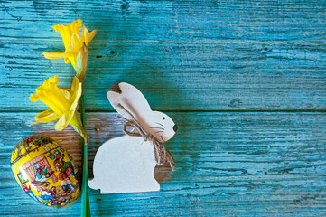 Wooden Easter bunny with flowers as decoration.