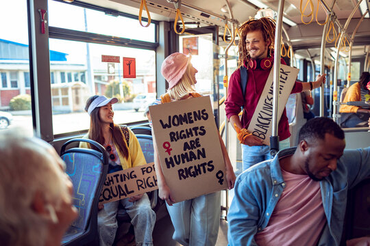 Activists with protest signs about climate change on a bus