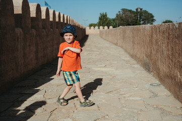 Fototapeta premium child boy on a tour in an ancient fortress