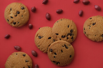 chocolate cookies on the background of a red tablecloth, for design. cookies with peanuts