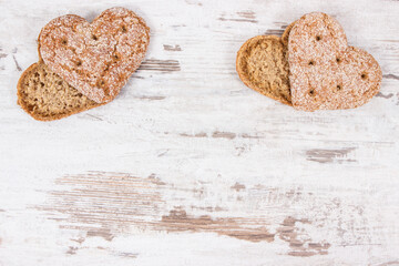 Fresh homemade wholegrain bread in shape of heart for breakfast. Copy space for text on old rustic...