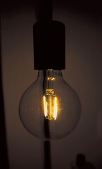 The light of a light bulb illuminates the darkness