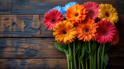 Tuinposter Colorful gerbera flowers on a rustic wooden background. © amixstudio