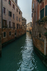 Typical narrow canal surrounded by buildings in Venice, Veneto, Italy