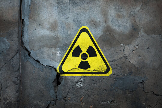 Radioactive sign on old cracked wall. Hazard symbol
