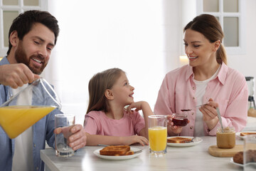 Obraz na płótnie Canvas Happy family having breakfast at table in kitchen