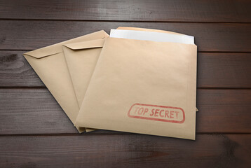 Top Secret stamp. Paper envelopes on wooden table