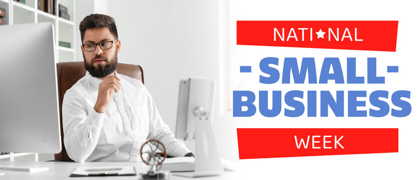 Thoughtful young bearded man at table in office - Powered by Adobe