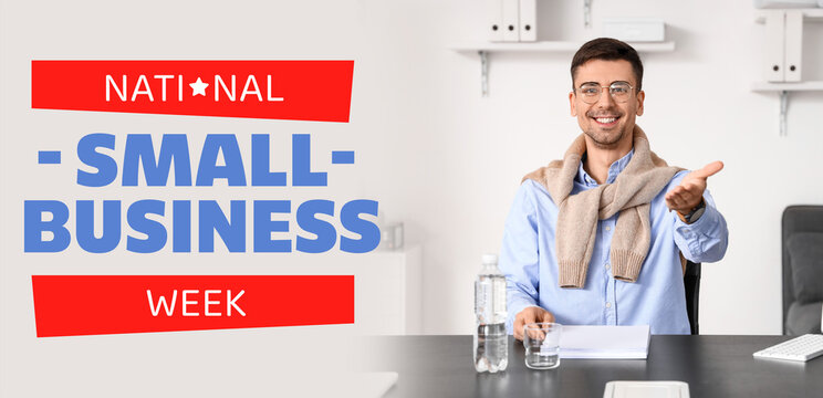 Smiling businessman working with documents at table in office - Powered by Adobe