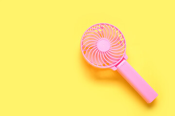 Modern manual fan on yellow background