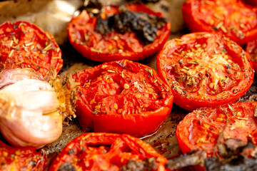 Baked tomatoes with garlic and spices for sauce. Appetizing photo. Macro