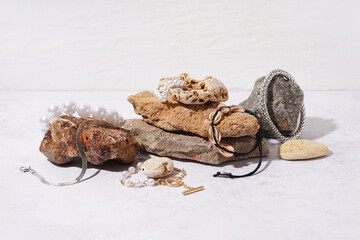 Stones with different stylish bracelets on grunge white background