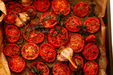 Baked tomatoes with garlic and spices for sauce. Appetizing photo