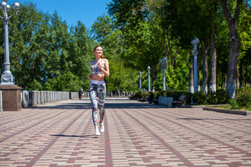 Fitness portrait young athletic woman running in summer park