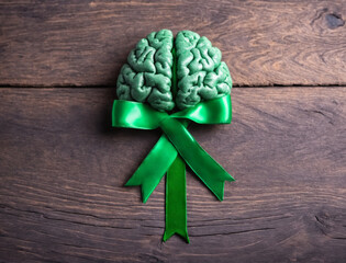 Green ribbon and brain symbol. Mental health awareness. - 769084474