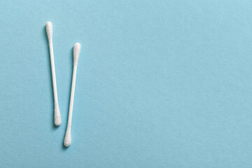 Ear sticks with cotton buds on blue background