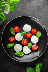 mozzarella salad caprese tomato, basil fresh food tasty eating appetizer meal food snack on the table copy space food background 