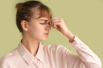 Tired young businesswoman on green background, closeup. Glaucoma awareness month