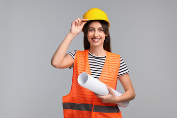 Architect in hard hat with draft on light grey background