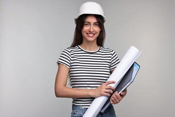 Architect in hard hat with draft and folder on light grey background