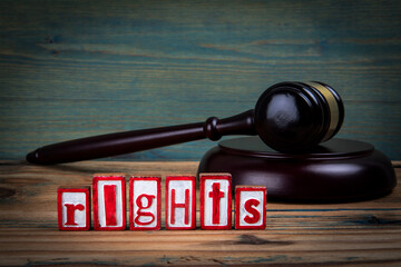 RIGHTS. Red alphabet letters and judge's gavel on wooden background. Laws and justice concept