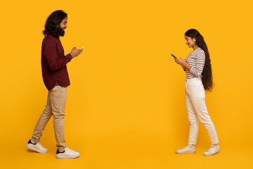 Fototapeta na wymiar Two people standing back to back texting