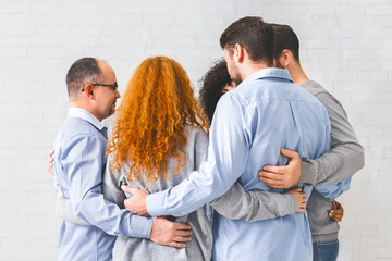 Group of people hugging in circle and supporting each other