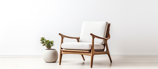 A comfortable chair made of wood is placed next to a rectangular potted houseplant in a room, adding a touch of nature to the furniture fixture on the flooring