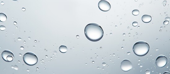 Focused on a cluster of small water droplets condensed on a clear window pane