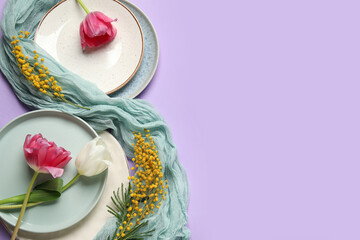 Beautiful table setting with mimosa flowers and tulips on lilac background