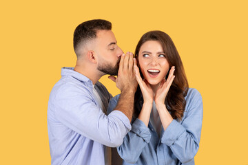 Man whispering to surprised woman