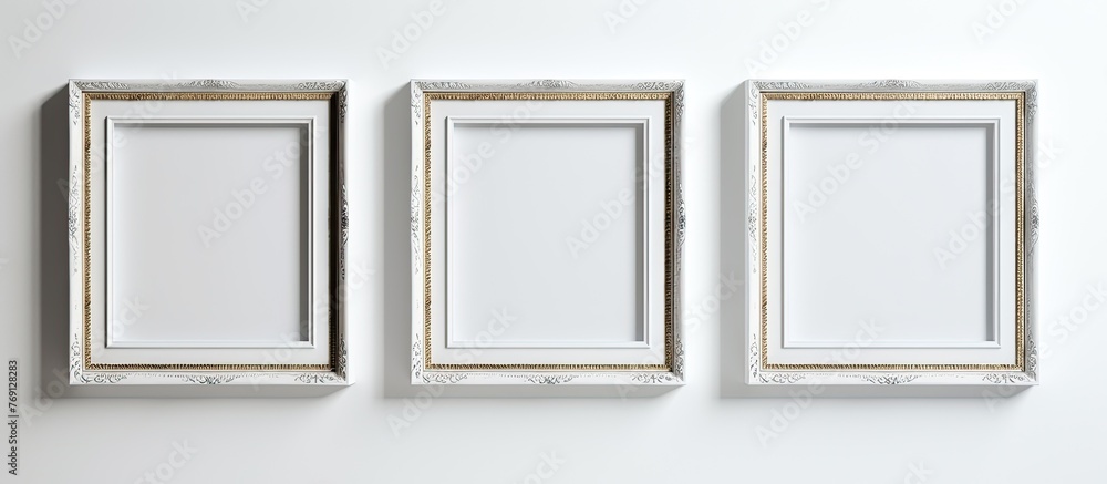Poster three rectangular picture frames made of metal and wood are fixed to a white wall. the art displayed