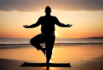 Silhouette of a overweight man practicing yoga on the beach at sunset. Healthy lifestyle concept, poster, banner, copy space.