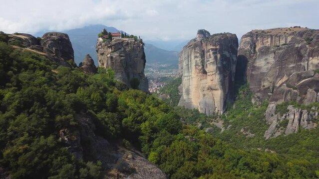 Aerial view of Monastery of the Holy Trinity (Agia Triada) in Meteora, Greece with Kalabaka town and mountains in the background