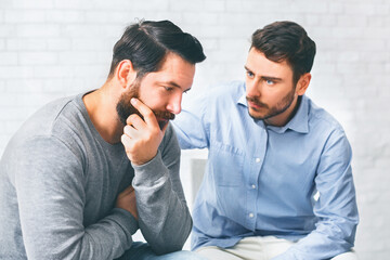 Understanding people giving support to depressed man at group therapy session