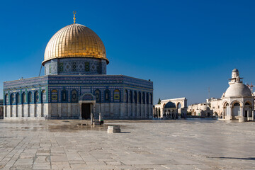 Dramatic image of the golden dome on the Temple Mount mosque in old city Jerusalem, Israel. With large courtyard in foreground.