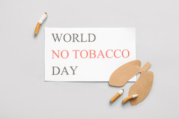 Card with phrase WORLD NO TOBACCO DAY, paper lungs and cigarette butts on light background. Stop...