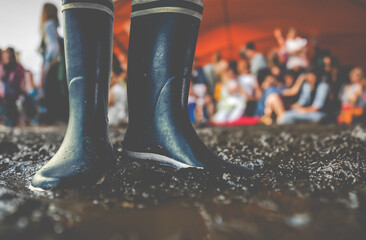 Rubber Boots In The Mud At A Music Festival - 769140064
