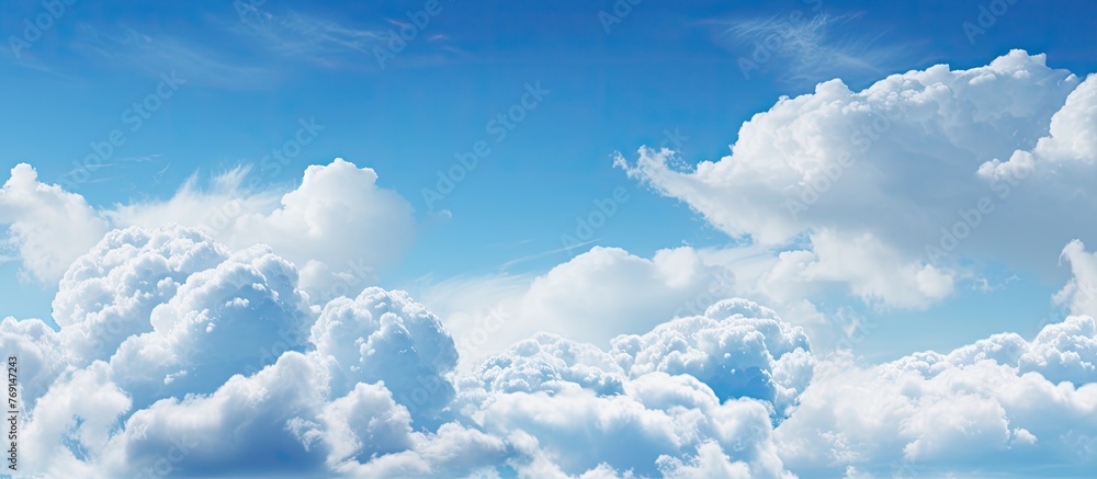 Wall mural scattered clouds in the sky are mirrored in tranquil water creating a serene and peaceful scene