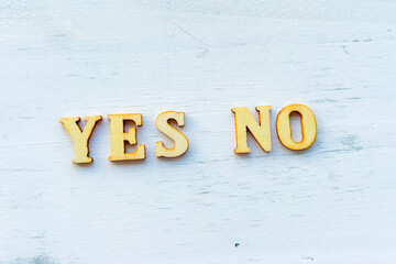 YES and NO sign on white wall