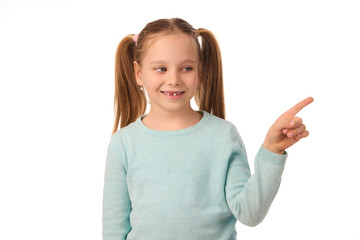 Adorable little girl pointing her index finger on white background